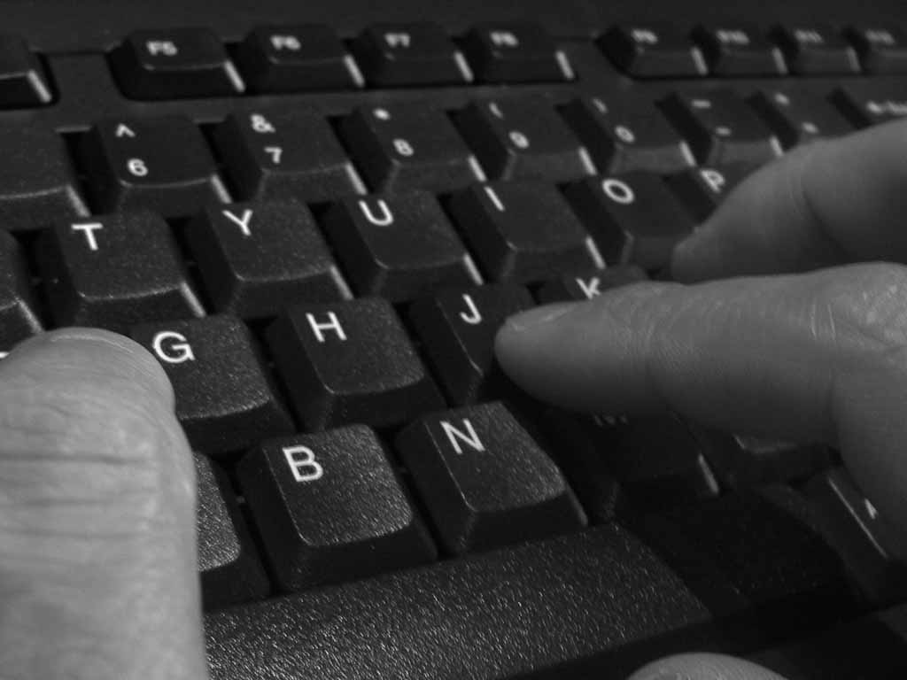Image Of Person Typing On A Computer Keyboard