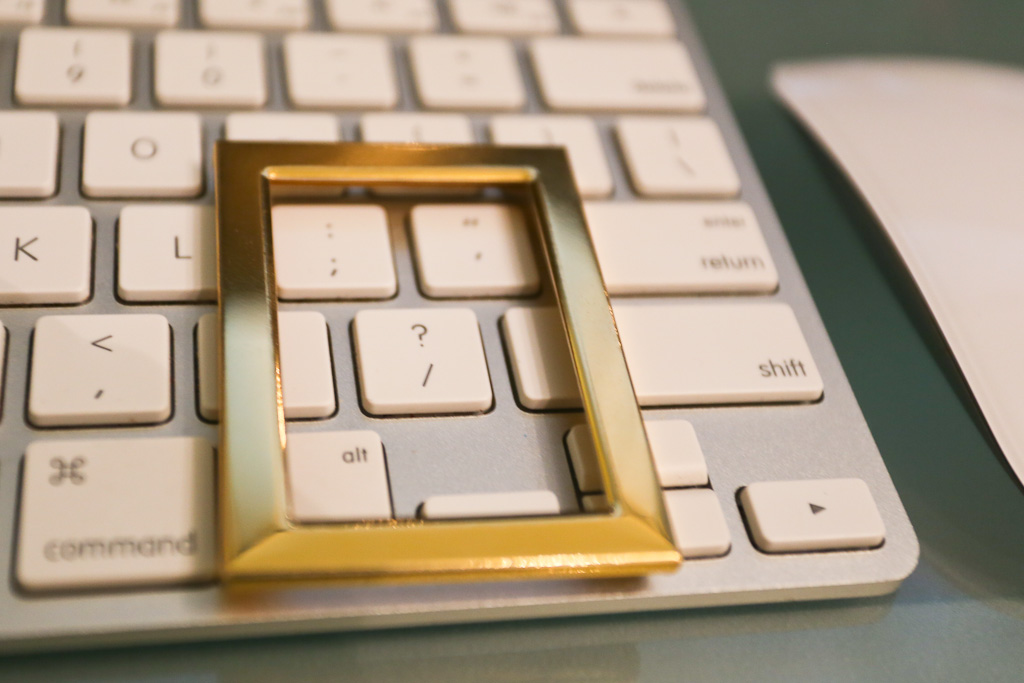 Image Of A Keyboard With A Picture Frame Over It Focused On A Question Mark.