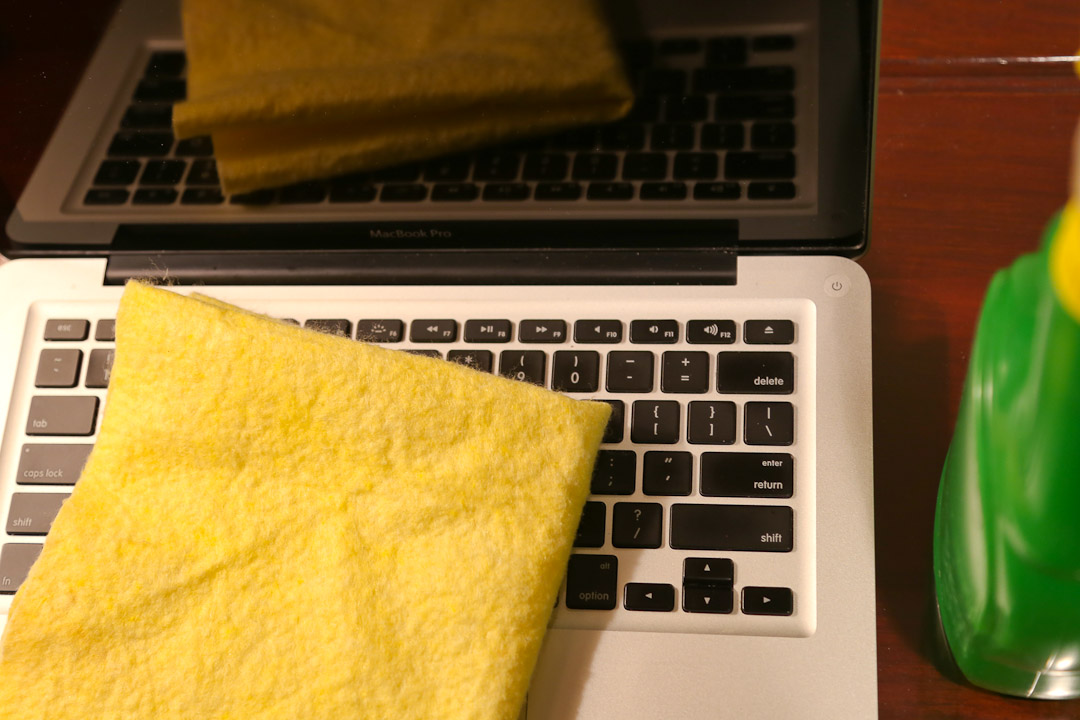 Image Of Laptop And Cleaning Supplies For Spring Clean Your Social Media Presence Blog Post