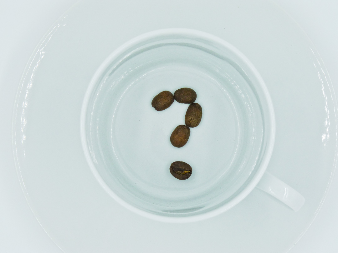 Coffee Beans In Question Mark Form In A Coffee Cup