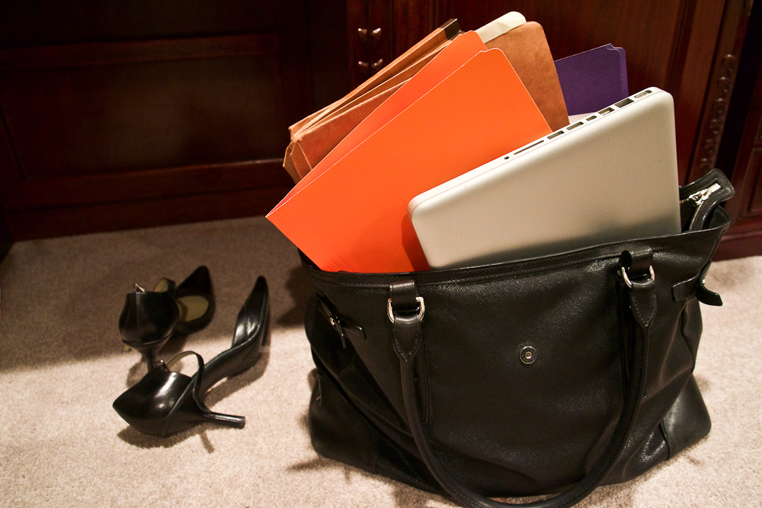 Image Of A Pair Of Shoes And Of A Bag With A Laptop And Files Inside Of It